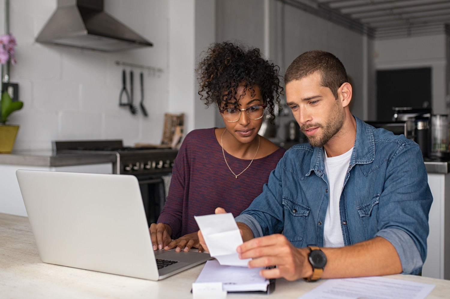 Man and woman managing money together at laptop